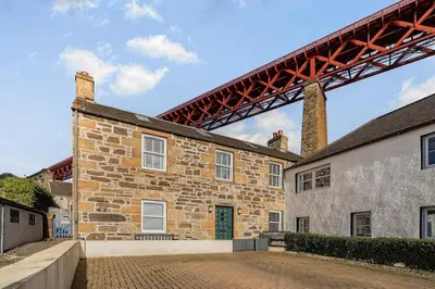 a large brick building with a bridge above it at The Old Jail - Iconic Views in North Queensferry