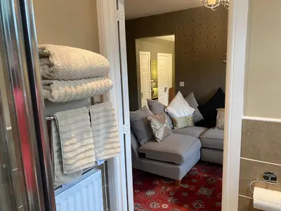 a living room with a couch and a chair at Doune Duck Ponds Accommodation in Doune