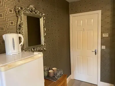 a kitchen with a mirror and a white refrigerator at Doune Duck Ponds Accommodation in Doune