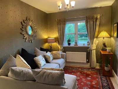 a living room with a couch and a window at Doune Duck Ponds Accommodation in Doune