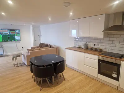 a kitchen with a table and a couch in a room at R&B Rentals in Moffat
