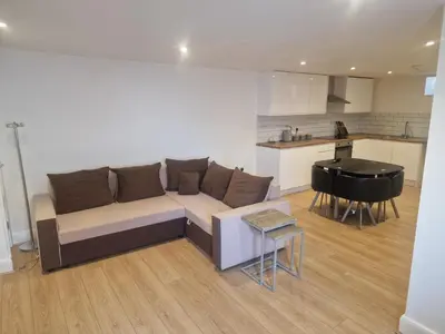 a living room with a couch and a kitchen at R&B Rentals in Moffat