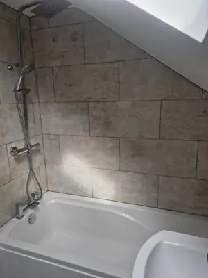 a bath tub in a bathroom with a shower at R&B Rentals in Moffat