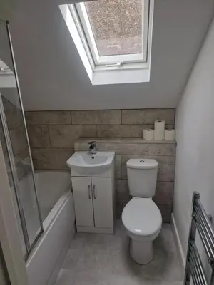 a bathroom with a toilet and a sink and a skylight at R&B Rentals in Moffat