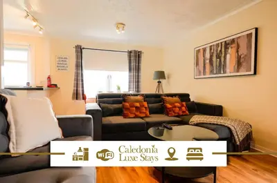 a living room with a couch and a table at 2 BDR Apt At Caledonia Luxe Stays Short Lets & Serviced Accommodation Airdrie in Airdrie