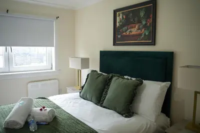 a bedroom with a bed with a stuffed animal on it at 2 BDR Apt At Caledonia Luxe Stays Short Lets & Serviced Accommodation Airdrie in Airdrie