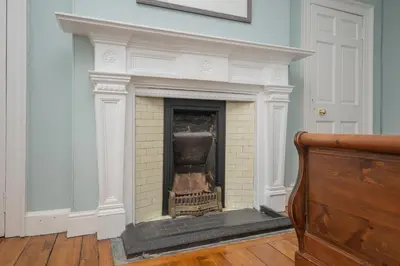 a white brick fireplace in a room at Banrigh House in Stirling