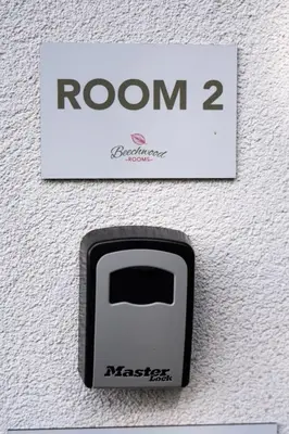 a sign that reads room with a black and white button at Beechwood in Oban