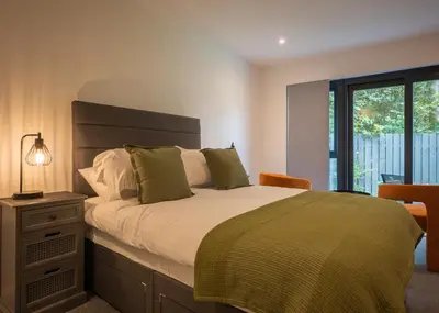 a bedroom with a large bed and a window at Beechwood in Oban