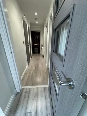 a door leading into a hallway with a wooden floor at LUXERY 1 Bedroom Apartment - Falkirk in Falkirk