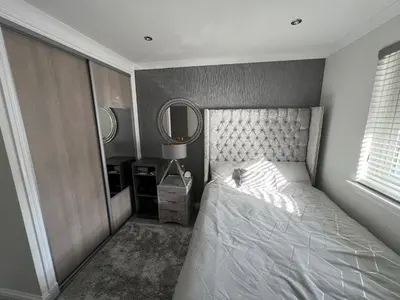 a bedroom with a white bed and a mirror at LUXERY 1 Bedroom Apartment - Falkirk in Falkirk