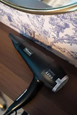 a hair dryer sitting on top of a table at Finnieston 1BR - Walk to Hydro & SEC - Parking in Glasgow