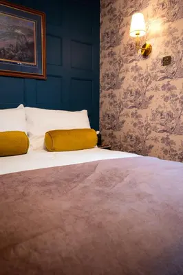 a bedroom with a large bed with yellow pillows at Finnieston 1BR - Walk to Hydro & SEC - Parking in Glasgow
