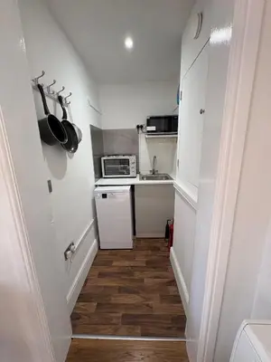 a small kitchen with a sink and a microwave at Muirside Cottage in Stirling