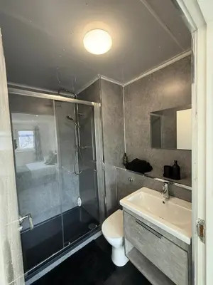a bathroom with a shower and a sink and a toilet at Luxurious 2BR, 8 mins from centre in Glasgow