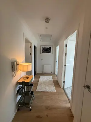 a hallway with a table and a desk in a room at Luxurious 2BR, 8 mins from centre in Glasgow