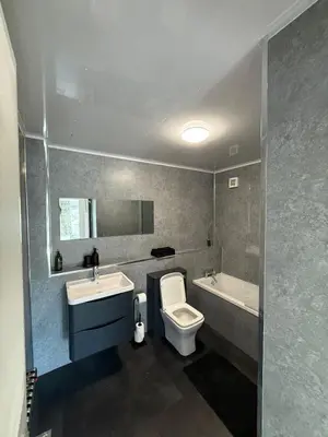 a bathroom with a toilet and a sink and a tub at Luxurious 2BR, 8 mins from centre in Glasgow