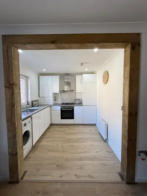 a kitchen with white cabinets and a washer and dryer at Luxurious 2BR, 8 mins from centre in Glasgow