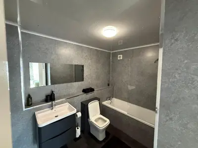 a bathroom with a toilet and a sink and a tub at Luxurious 2BR, 8 mins from centre in Glasgow