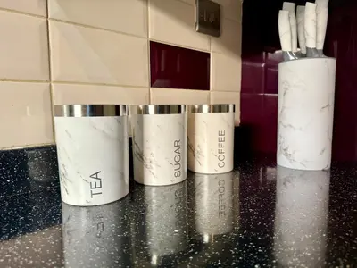 three cups sitting on a counter in a kitchen at Modern 4-Bed Family Home in Solihull in Moffat