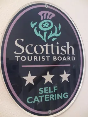 a sign for a scottish tourism council board at Silver Tides House in Greenock