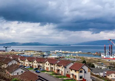 a view of a city with houses and the water at Silver Tides House in Greenock