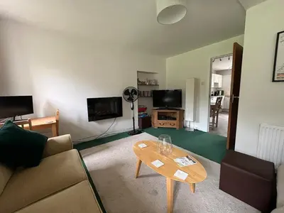 a living room with a couch and a table at Allt-Na-Craig Coach House - Ardrishaig in Ardrishaig