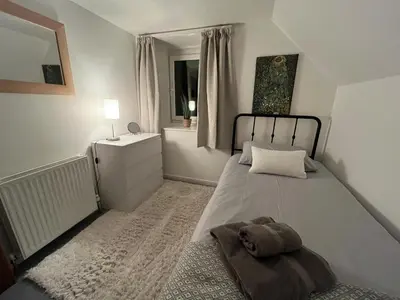 a bedroom with a large bed and a window at Allt-Na-Craig Coach House - Ardrishaig in Ardrishaig