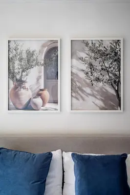 two framed pictures on a wall above a couch at Cozy 2 bedroom London Flat in Heart of Pimlico in Moffat