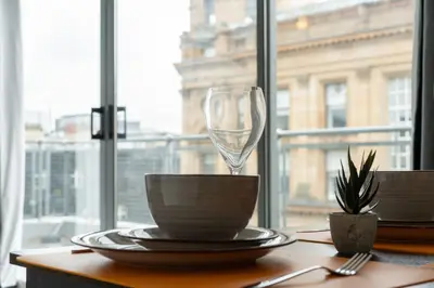 a table with a wine glass on top of it at Buchanan Penthouse in Glasgow