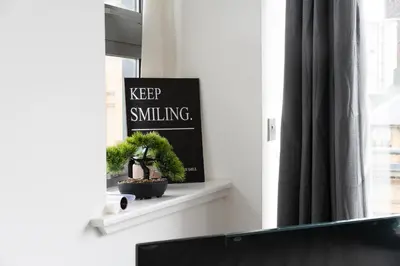 a window sill with a sign that says keep smiling at Buchanan Penthouse in Glasgow