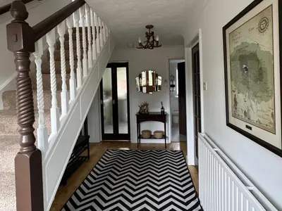 a hallway with stairs with a black and white rug at Tickety-Boo Luss Loch Lomond in Luss