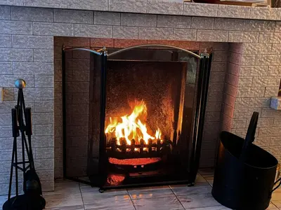 a fireplace with a roaring fire in it at Tickety-Boo Luss Loch Lomond in Luss