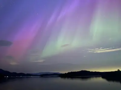a beam of light over a lake at night at Tickety-Boo Luss Loch Lomond in Luss