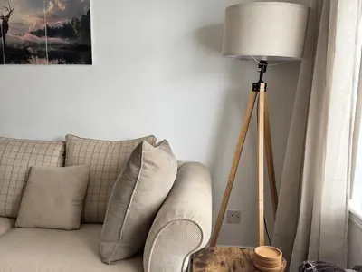 a living room with a couch and a lamp at Tickety-Boo Luss Loch Lomond in Luss