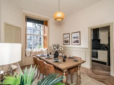 a living room with a wooden table and chairs at Pass the Keys Beautiful Modern Historical Flat Close to Castle in Edinburgh