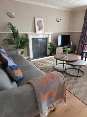 a living room with a couch and a table at 3BR House with Parking 10 Mins to Airport Sleeps 6 in EDI