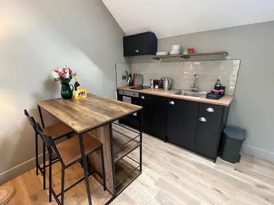 a small kitchen with a table and a sink at Kilmory Sea View in Lochgilphead