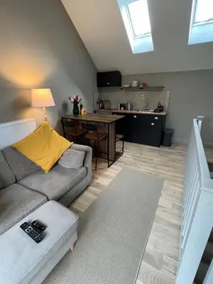 a living room with a couch and a table at Kilmory Sea View in Lochgilphead