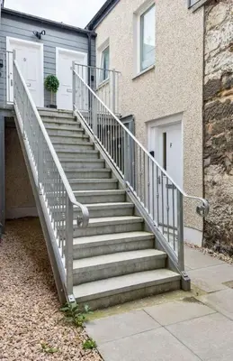 a set of stairs leading to a house at Stirlings Hidden and Tranquil Studio Apartment in Stirling
