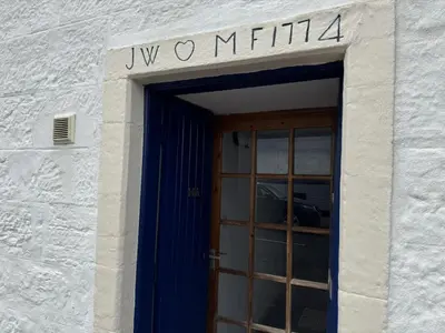a door to a building with a sign above it at Watt-A-View in Limekilns