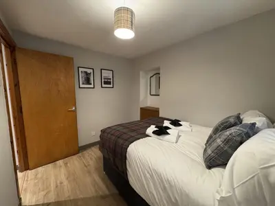 a bedroom with a bed with a cat on it at Watt-A-View in Limekilns