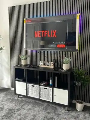 a tv sitting on top of a entertainment center at Sugar boat view in Greenock
