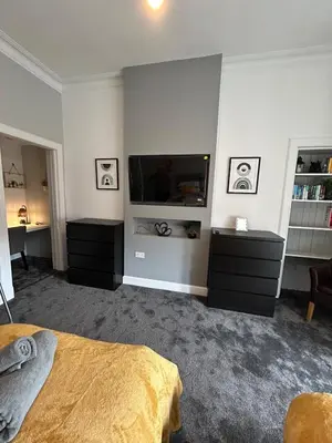 a bedroom with a bed and a flat screen tv at Sugar boat view in Greenock