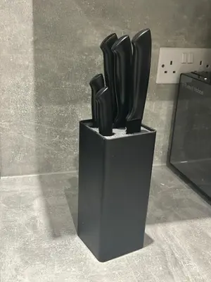 a black vase with a group of objects in it at Sugar boat view in Greenock