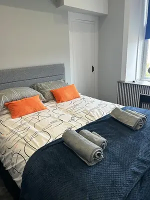 a large bed with two pillows on top of it at Sugar boat view in Greenock
