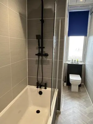 a bathroom with a bath tub and a toilet at Sugar boat view in Greenock