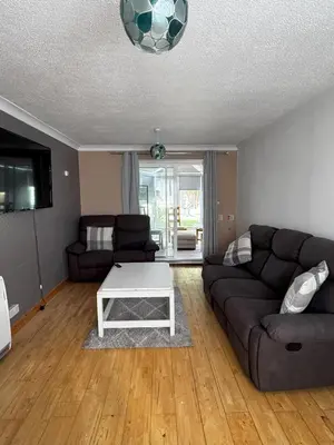 a living room with a couch and a coffee table at Honey House in Moffat
