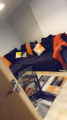 a couch with pillows on it in a room at The friendly place in Glasgow