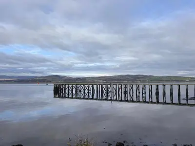 a wooden dock in the water on a lake at Stag & Stay- Waterlillie - Contractor friendly, Fast WiFi in Port Glasgow